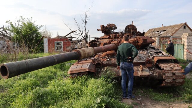A destroyed Russian tank in a village