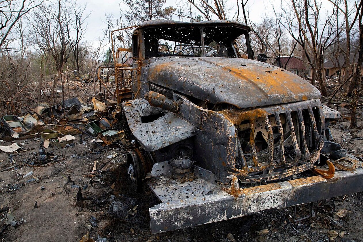 A burned truck in a forest